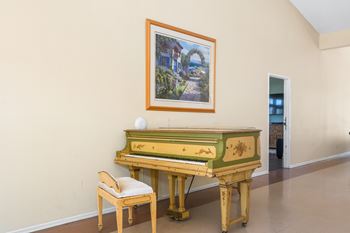 A green piano with a white ball on top of it.